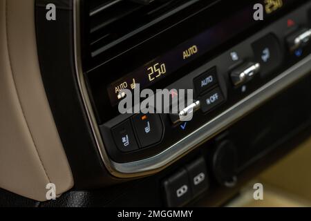 Buttons for warmer air and cooler air. Buttons to control air temperature inside car. Button of the air conditioner in the car Stock Photo