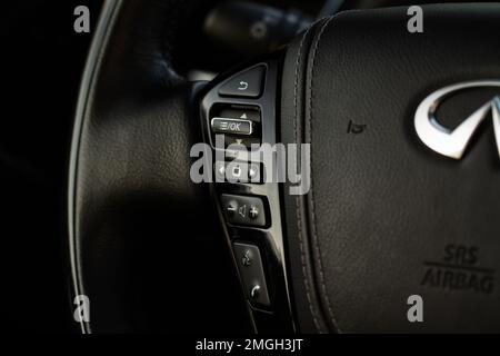 MOSCOW, RUSSIA - DECEMBER 11, 2021 Infiniti QX80 (QX56) Call buttons on car steering wheel. Audio control buttons on the steering wheel of a modern ca Stock Photo