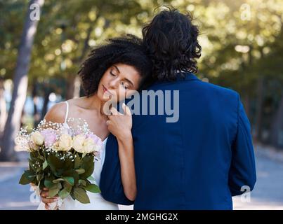 Married couple, bride and groom hug with love, care and celebration in outdoor garden. Wedding, marriage and romance with calm support, trust and Stock Photo