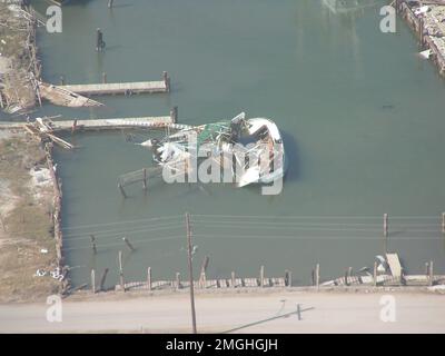 Aftermath - Jefferson Parish - 26-HK-38-47. overturned, destroyed boat near dock. Hurricane Katrina Stock Photo