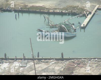 Aftermath - Jefferson Parish - 26-HK-38-46. overturned boat near dock. Hurricane Katrina Stock Photo