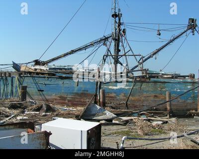 Aftermath - Jefferson Parish - 26-HK-38-29. damaged, displaced vessel amid debris. Hurricane Katrina Stock Photo