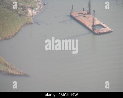 Aftermath - Jefferson Parish - 26-HK-38-3. barge on water near embankment. Hurricane Katrina Stock Photo