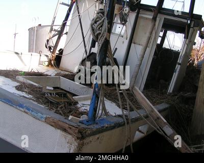 Aftermath - Jefferson Parish - 26-HK-38-22. close-up of damaged, displaced vessel. Hurricane Katrina Stock Photo