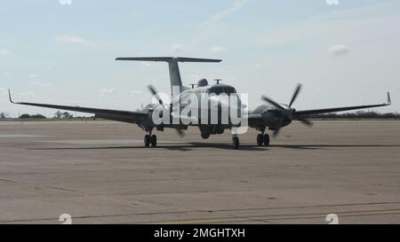 An MC-12W assigned to the 137th Special Operations Wing, Oklahoma National Guard, taxis into a hangar at San Angelo Regional Airport-Mathis Field, Texas, Aug. 24, 2022. The MC-12W is a twin-engine turbo prop aircraft used for intelligence, surveillance and reconnaissance missions in support of ground forces around the world. Stock Photo