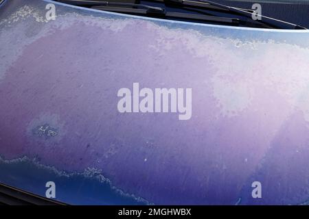 car used peeling blue paint on grunge hood of old automobile Stock Photo