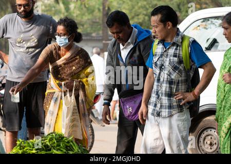 Puttaparthi, Andra Pradesh - India - January 21.2023: A man on the local Indian vegetable market in Puttaparthi Stock Photo