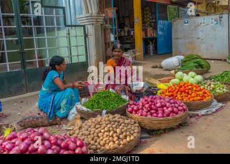 Puttaparthi, Andra Pradesh - India - January 21.2023: Two women at the local Indian vegetable market Stock Photo