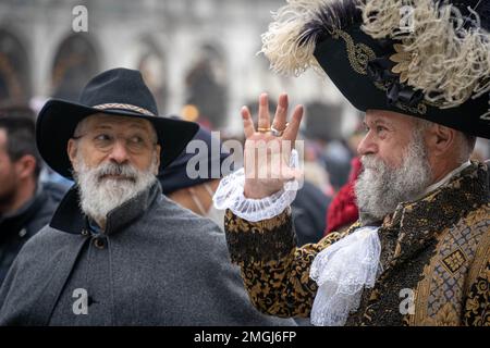 Two intelligent gray-haired aged men with a beard and mustache dressed in old style hats and suits at the carnival in Venice, Italy Stock Photo