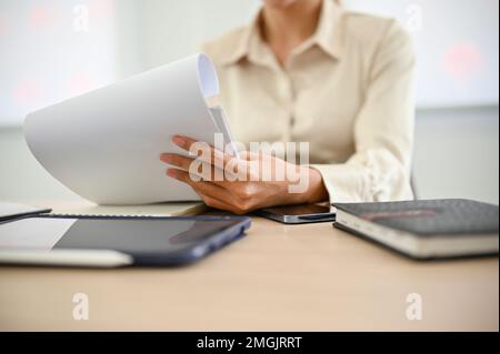 A businesswoman or female accountant examining sales and financial report at her desk. cropped image Stock Photo