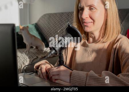 Female Solo Podcasting - Home studio recording. Stock Photo