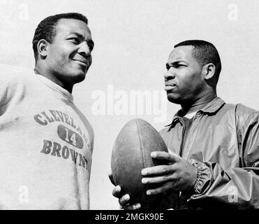 FILE - In this October 1960 file photo, Cleveland Browns fullback Jim Brown  (32) runs with a reception as Dallas Cowboys' Tom Franckhauser (32) defends  and Don Healy falls to the turf