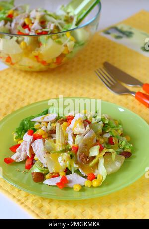 Salad with boiled chicken meat,pineapple,raisin and corn with honey-mustard  sauce. Topped with sesame seeds Stock Photo