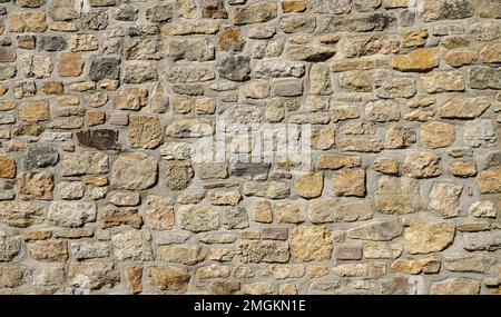 Light brown antique stone wall as background. Stock Photo