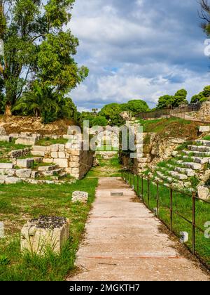 Roman amphitheatre of Syracuse - I cent. AD - III cent. AD - Neapolis Archaeological Park - Syracuse, Sicily, Italy The amphitheatre has two entrances and is served by a complex system of stairs that descend from the upper level located outside. The arena was equipped, in the center, with a large rectangular room, originally covered, connected via an underground passage with the southern end of the monument, on the axis of the entrance corridor. Around the arena the cavea is distinguished by a high podium, behind which runs a covered corridor with gates for access to the arena for gladiators a Stock Photo