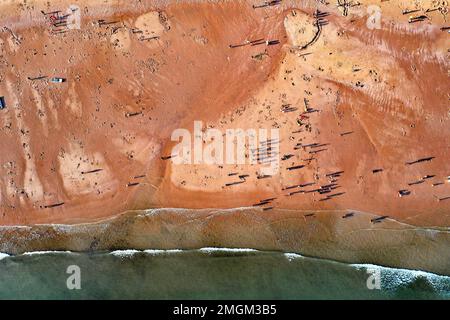 Fangchenggang, China's Guangxi Zhuang Autonomous Region. 25th Jan, 2023. In this aerial photo, tourists visit a beach in the coastal city of Fangchenggang, south China's Guangxi Zhuang Autonomous Region, Jan. 25, 2023. Credit: Yang Wenbin/Xinhua/Alamy Live News Stock Photo