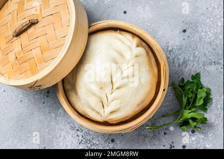 Pyanse steamed bun in a Bamboo steamer, korean street food. Isolated on