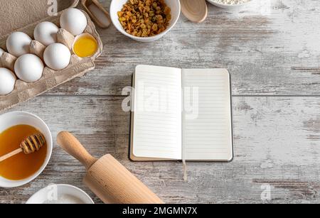 Notepad and baking products on the table. Stock Photo
