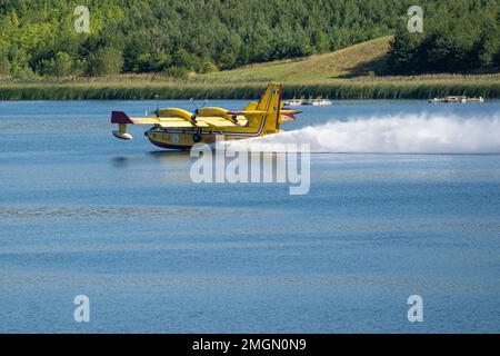 Lake Milada near Ústí nad Labem, a firefighting plane prepares to collect water, summer 2022. It collects water in flight directly from the lake and t Stock Photo