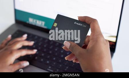 Ecommerce, credit card and typing on laptop while doing online shopping with fintech technology with closeup of woman hands. Paying bills, order and Stock Photo