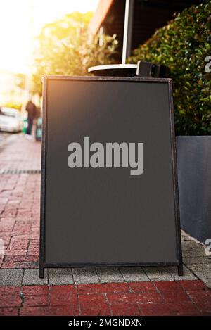 Something to make your day. a sidewalk sign with space for you to add your own text. Stock Photo