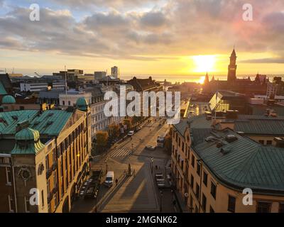 An aerial shot of the Helsingborg city in Sweden with the sea and the golden sunset in the background Stock Photo