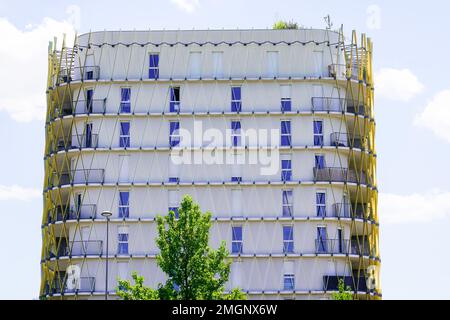 Facade of modern apartment building with wooden decoration balcony on a sunny day Stock Photo