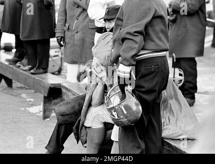 New York Giants quarterback Y.A. Tittle (14) is assisted from the playing  field on Dec. 29, 1963 at Wrigley Field in Chicago by teammate Hugh  McElhenney (39) after Tittle was injured in