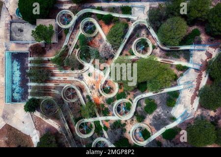 Aerial view of an abandoned old gloomy water park due to bankruptcy. Taken from a drone. Creative abstract Stock Photo