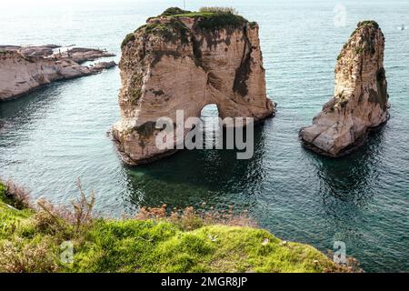 Raouche Rocks in Beirut, Lebanon in the sea during daytime. Pigeon Rocks in Mediterranean Sea. Popular Tourist Destination in Beirut. Stock Photo