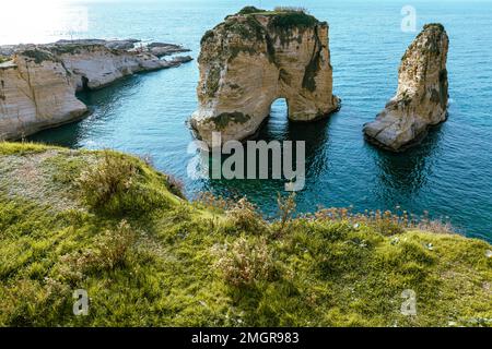 Raouche Rocks in Beirut, Lebanon in the sea during daytime. Pigeon Rocks in Mediterranean Sea. Popular Tourist Destination in Beirut. Stock Photo