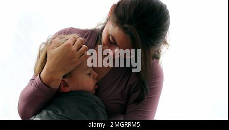 Tired child on mother lap in the verge of napping kid falling asleep Stock Photo