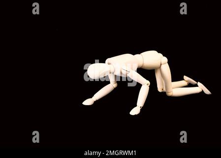 Den Helder, Netherlands. January 2023. Wooden dummies in different poses on a black background. High quality photo Stock Photo