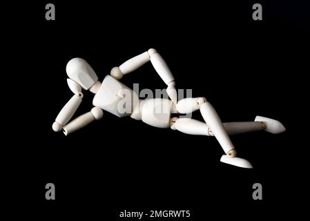 Den Helder, Netherlands. January 2023. Wooden dummies in different poses on a black background. High quality photo Stock Photo