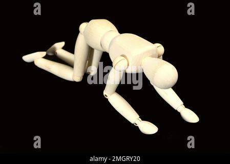 Den Helder, Netherlands. January 2023. Wooden dummies in different poses on a black background. High quality photo Stock Photo