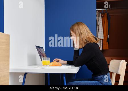 Woman watches tutorial video about cooking and making healthy food Stock Photo