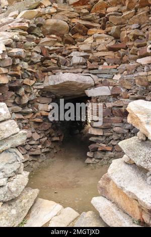 Cairn de Barnenez is a Neolithic stone mound near Plouezoc'h in Brittany Stock Photo