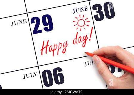 29th day of June. Hand writing the text HAPPY DAY and drawing the sun on the calendar date June 29. Save the date. Holiday. Motivation. Summer month, Stock Photo