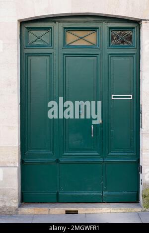 green door home entrance wooden double doors painted in Paris Stock Photo