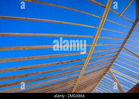Construction of framed structure consists an interior beam composed wood board attached to roof support trusses Stock Photo