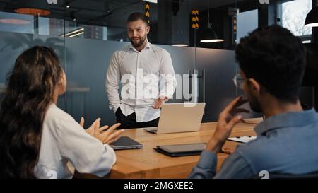 Business people group listening to businessman leader boss man company CEO presentation discussing project results at board meeting in office Stock Photo