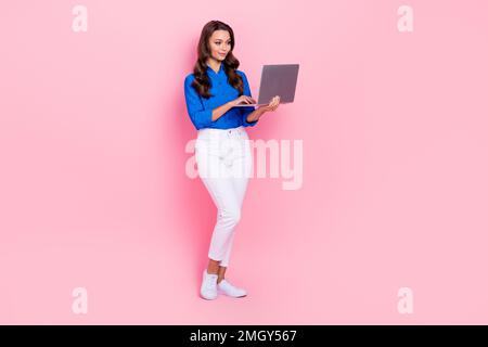 Full body size cadre of confident engineer expert lady wear formal outfit hold netbook keyboard office computer isolated on pink color background Stock Photo