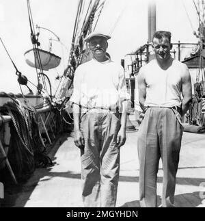 Two sailors standing on the deck of the four-masted steel barque Hougomont, circa 1928. Stock Photo