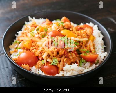 TVP granules, cabbage in a tomato sauce served on rice. Stock Photo
