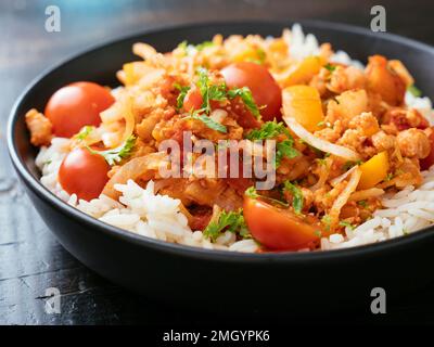 TVP granules, cabbage in a tomato sauce served on rice. Stock Photo