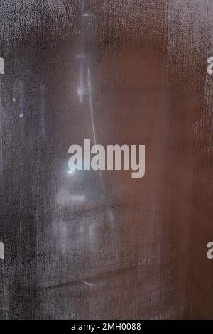 photo shower enclosure with shower accessories through fogged glass Stock Photo
