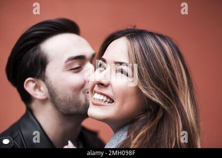 stylish happy couple enjoying a date on the street of a European city Stock Photo