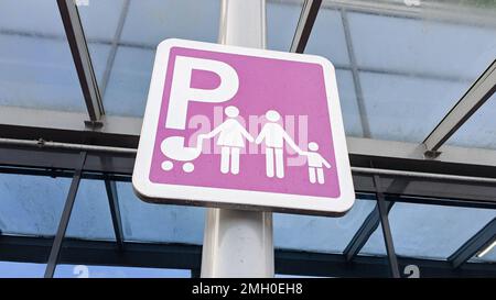 family parking car places in public parked road signs Stock Photo