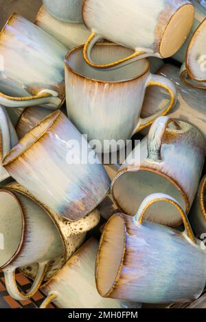 Handmade ceramic mugs stacks background Stock Photo