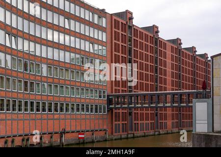 An eight-story modern parking garage beside a canal in the maritime warehouse complex Speicherstadt Hamburg. Stock Photo